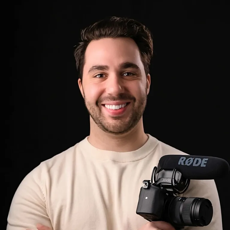 Josh Gonsalves, smiling, holding a camera